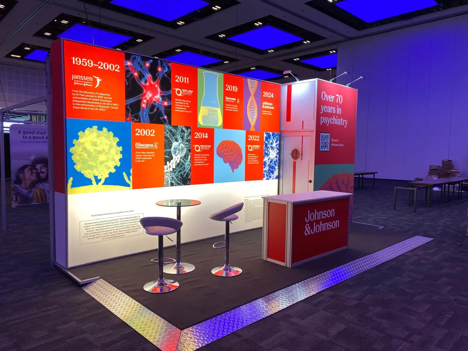 Custom trade show exhibition booth design, branded wall backdrop graphics, and reception counter branding in Uganda