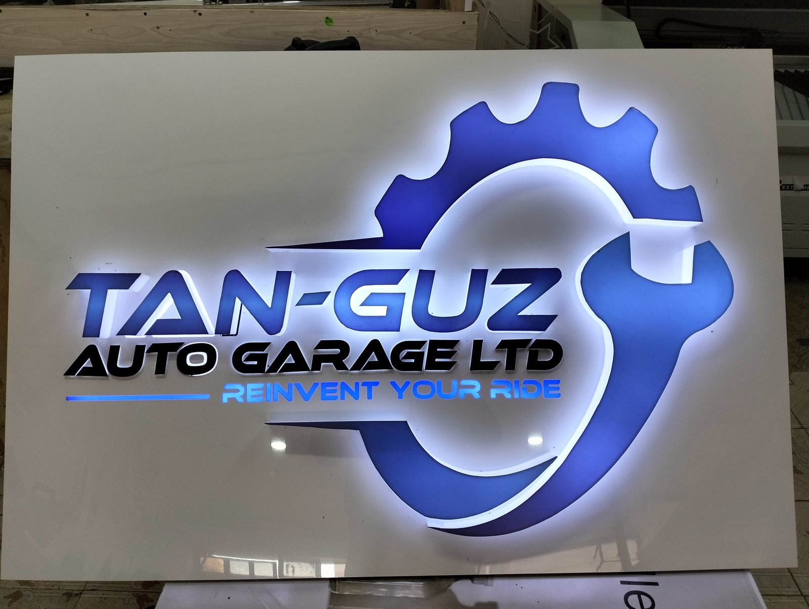 Illuminated 3D back-lit logo signage and wall branding for Tan-Guz Auto Garage Ltd in Uganda