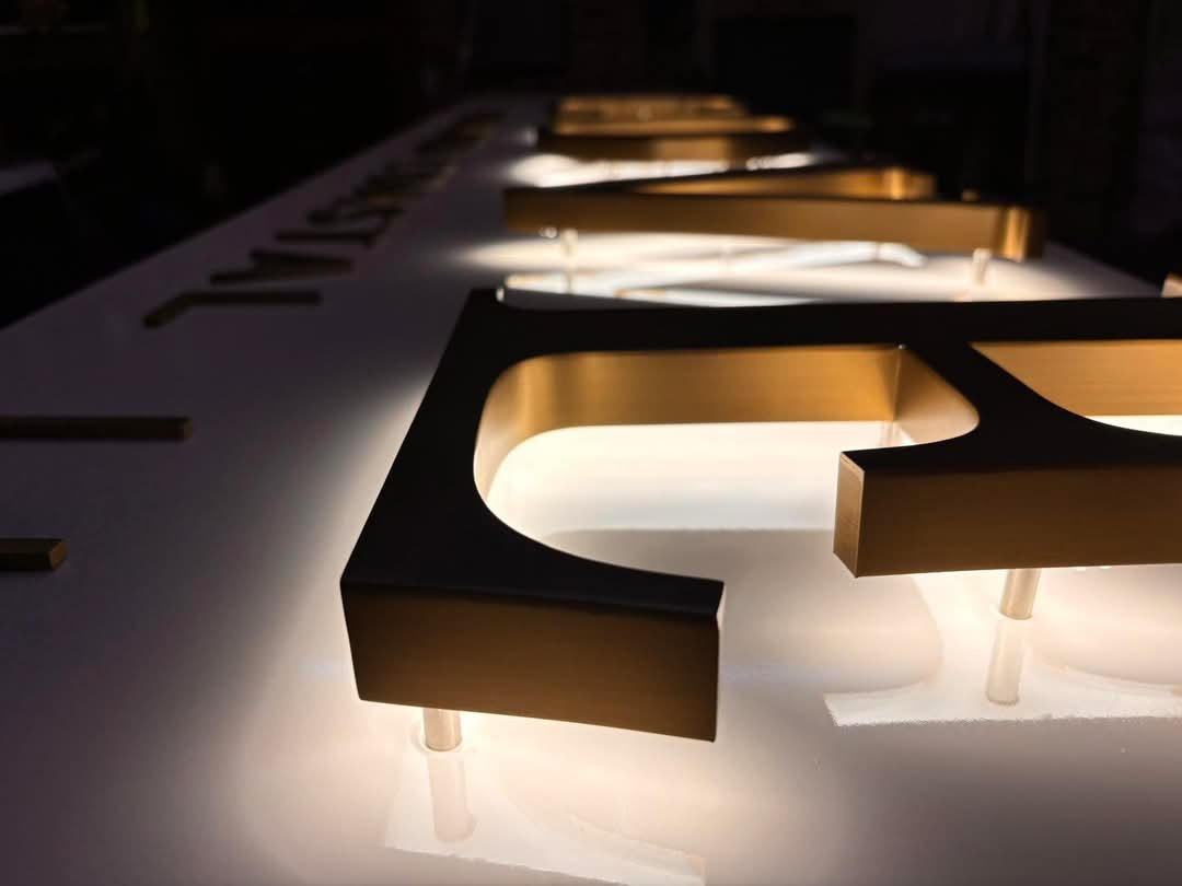 Brushed Brass Halo-Lit Channel Letters with Standoff Mounts