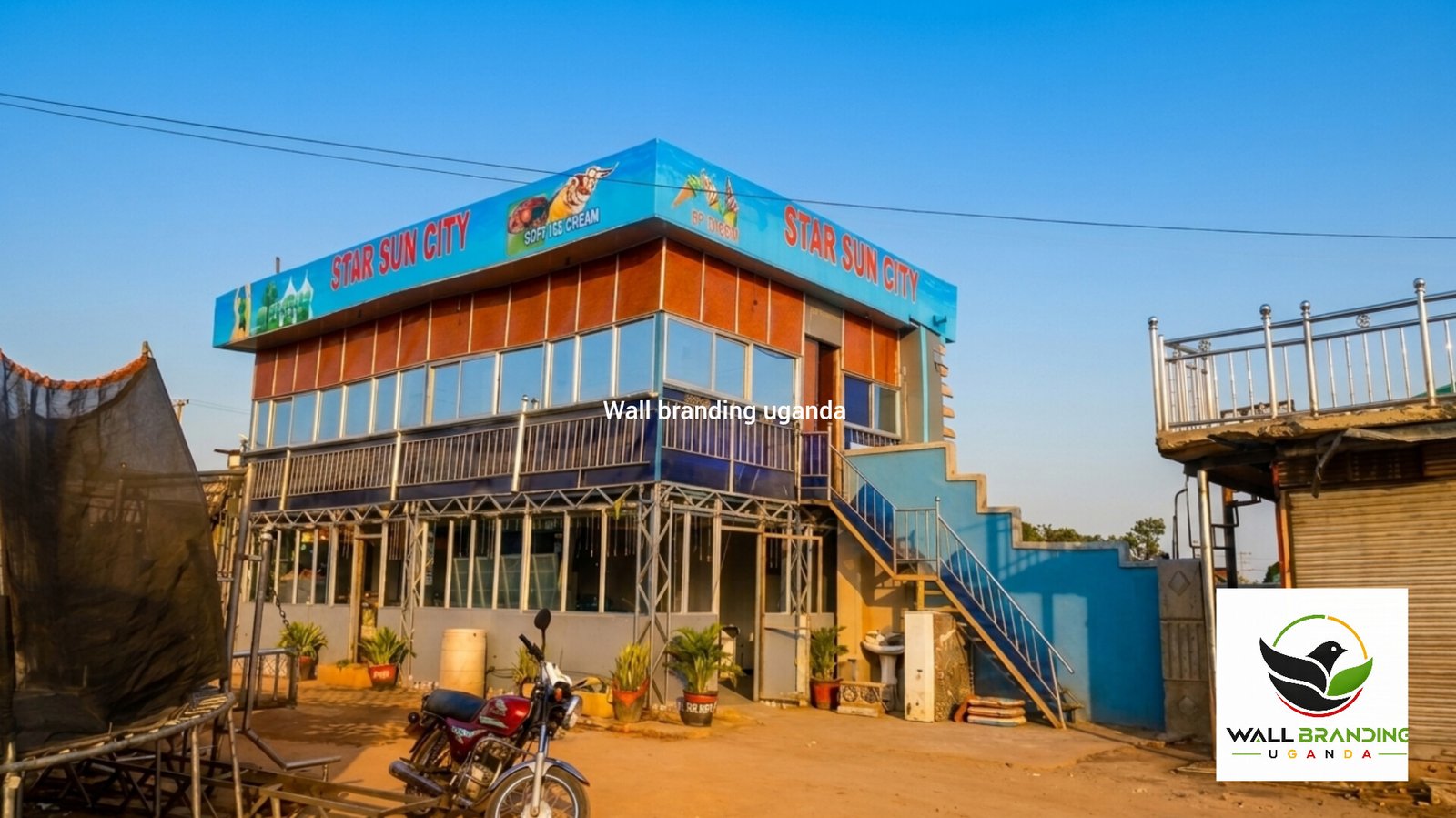 Painted canopy fascia and roof-line branding advertisement for Sun City Park in Uganda