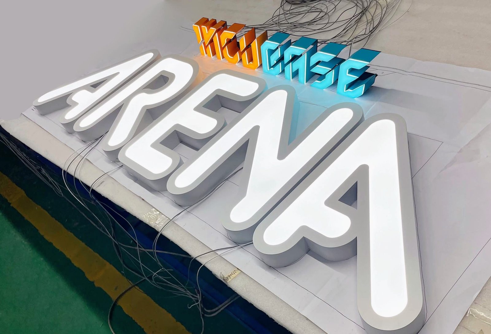 3D front-lit channel letters featuring custom orange, blue, and white acrylic faces for commercial arena facade in Entebbe, Uganda.