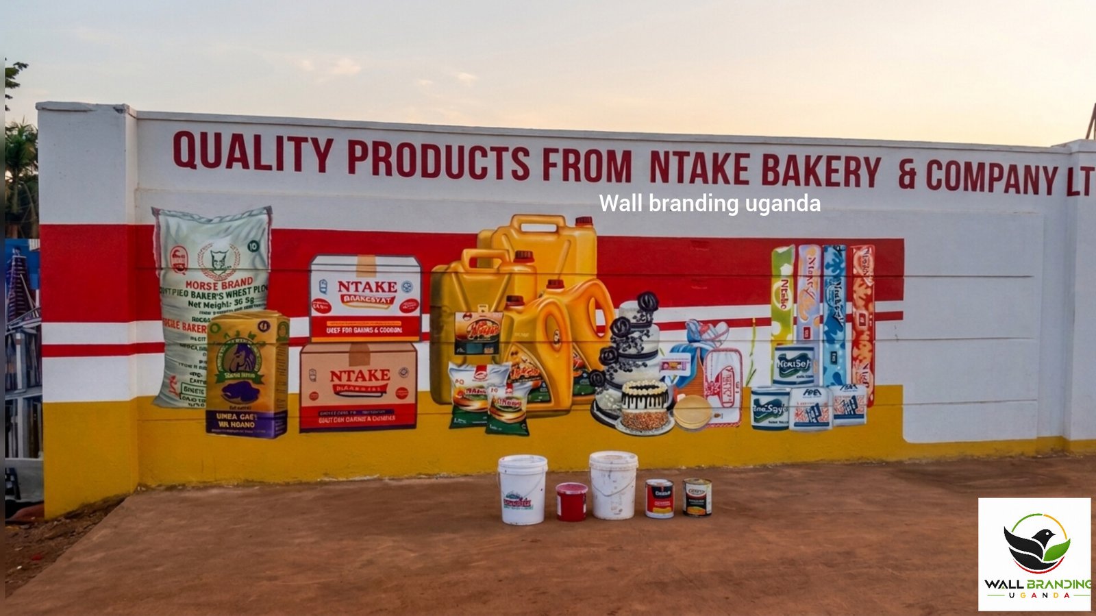 Perimeter fence wall branding and multi-brand corporate logo painting along a commercial boundary in Uganda